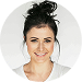 Woman with a bun hairstyle against a neutral background