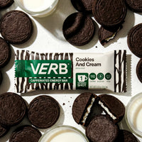 Verb energy bar with cookies and cream flavor surrounded by cookies and a glass of milk.